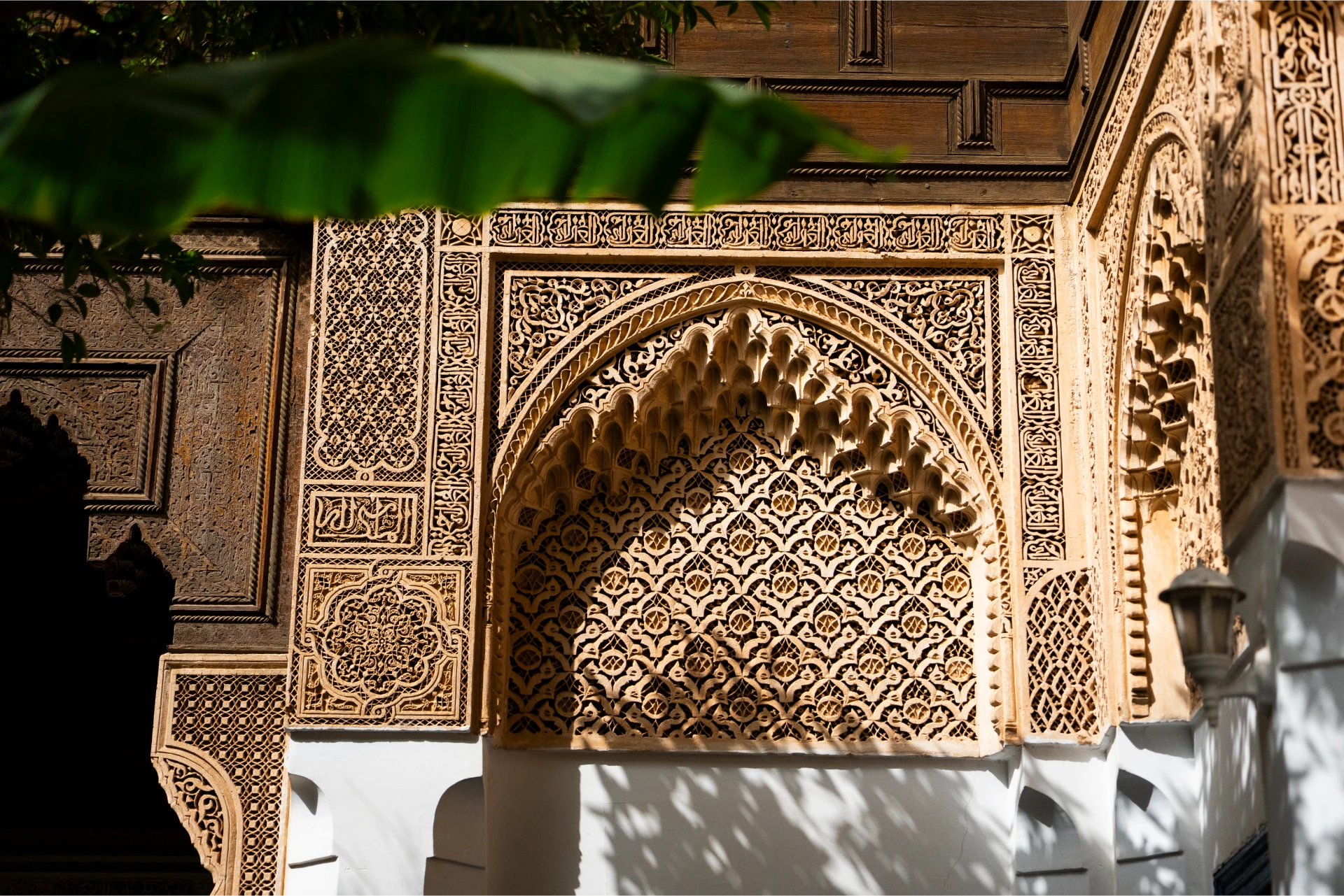 A zellige-tiled archway in a historic courtyard in Morocco