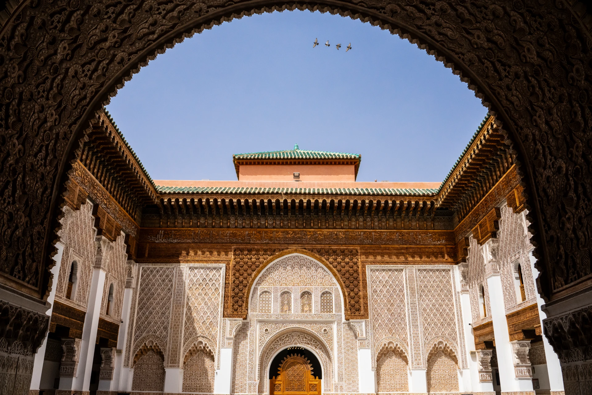 The arched courtyard and carved stucco of the Ben Youssef Madrasa in Marrakech