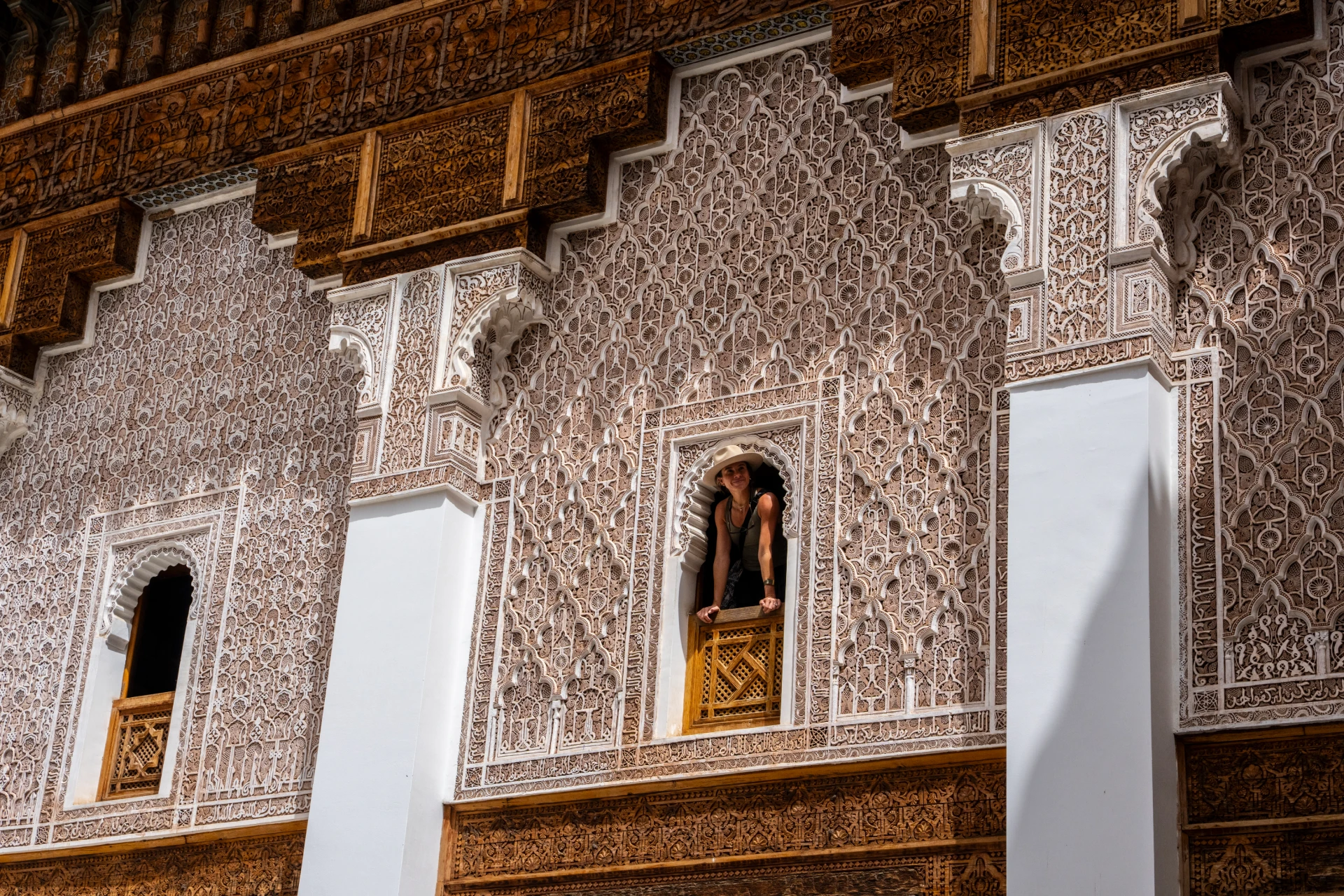 The carved stucco walls of the Ben Youssef Madrasa courtyard in Marrakech