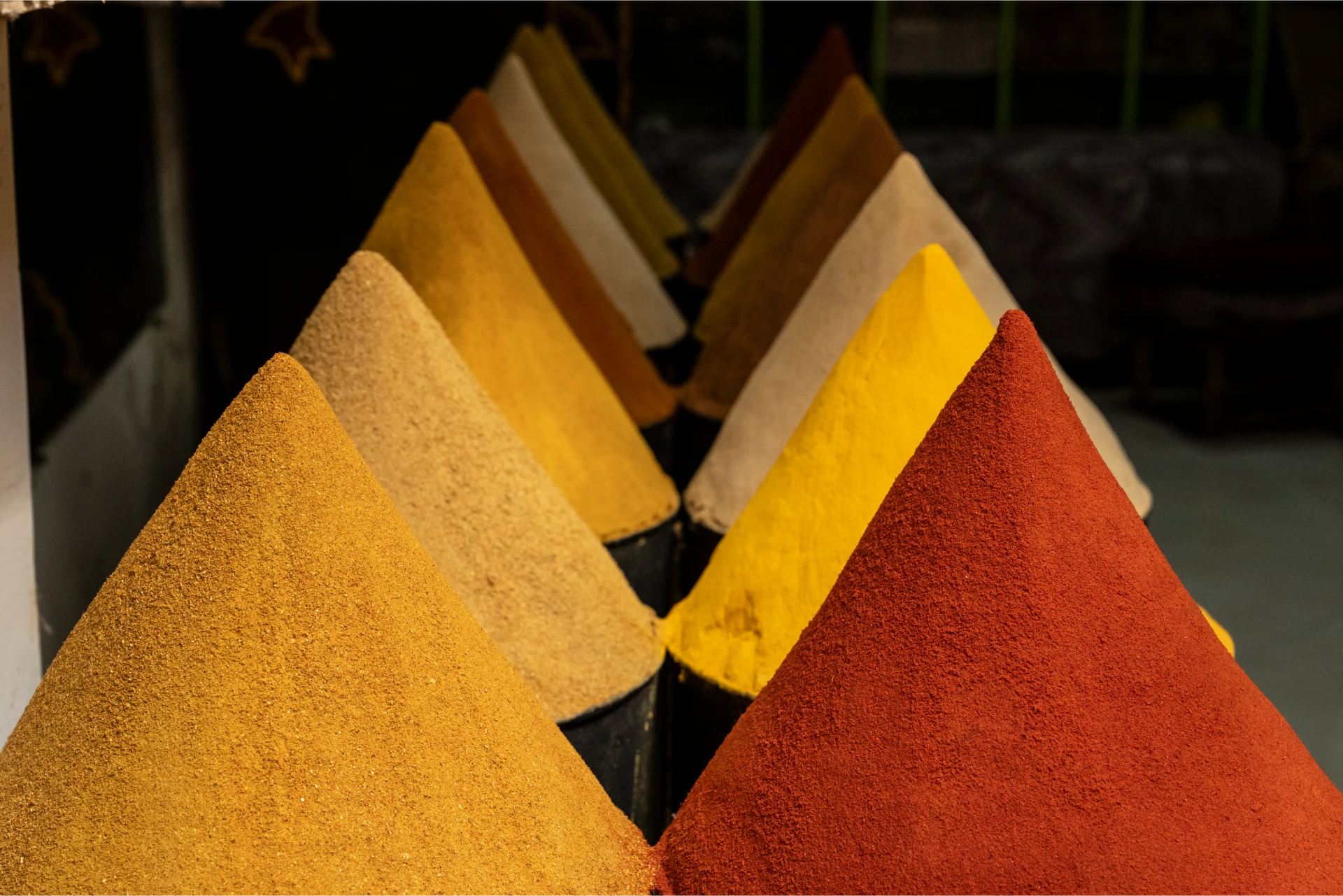Cones of colorful ground spices piled high at a Moroccan souk stall