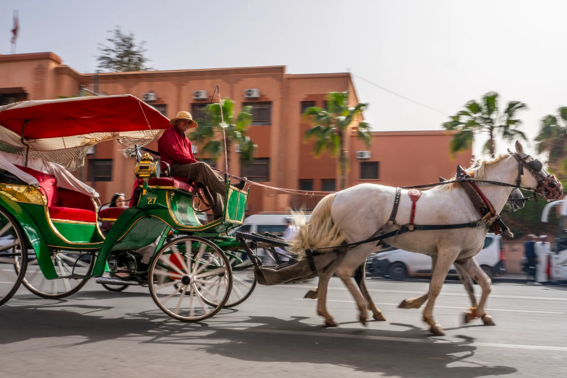 A horse-drawn caleche on a sunny street in Marrakech