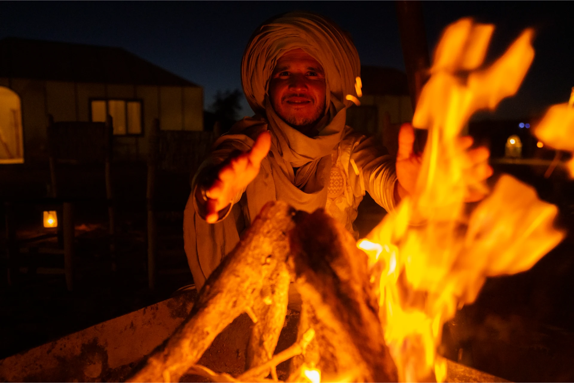 A campfire burning at a private Sahara camp at night