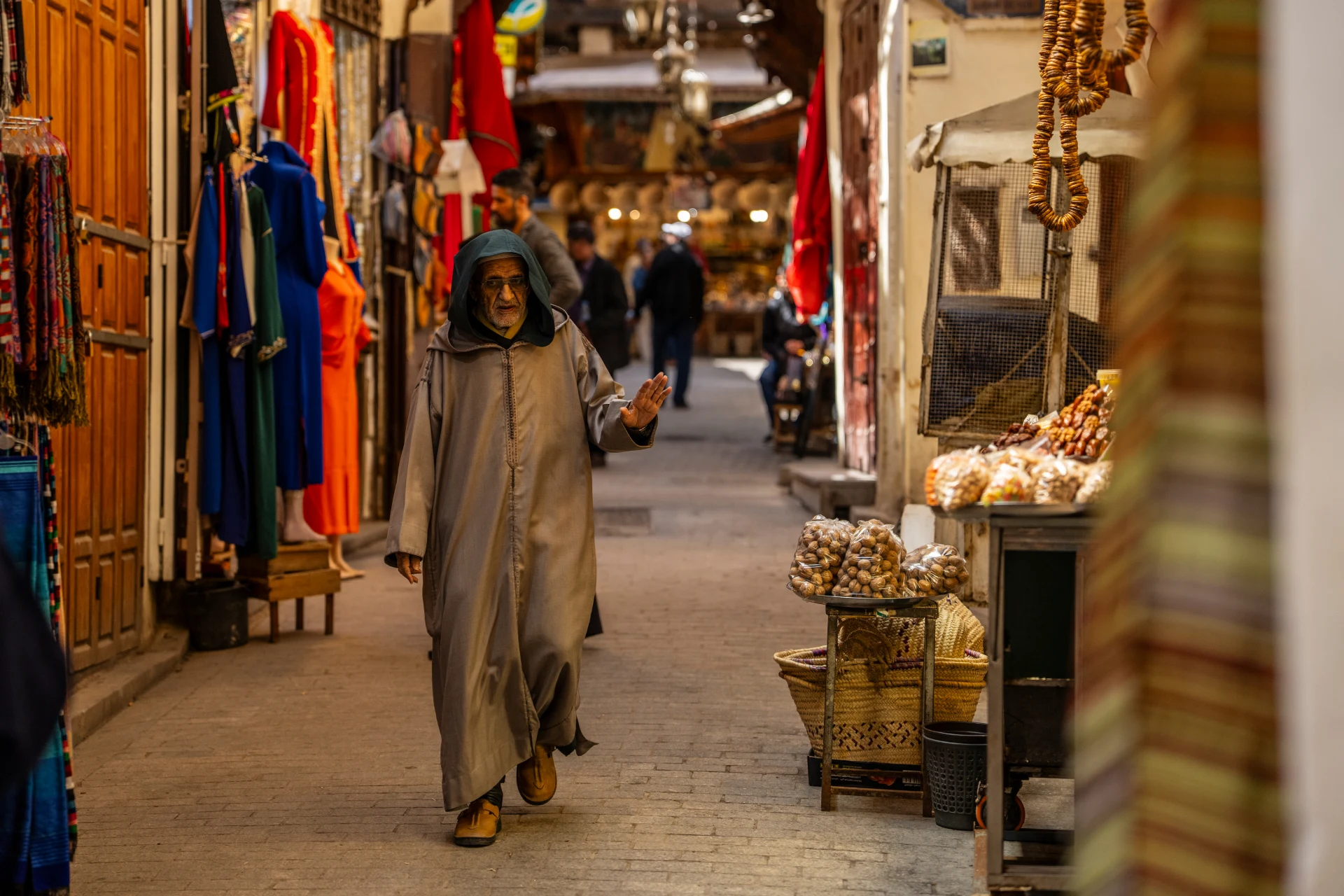 A narrow lane in the Fes medina lined with shops